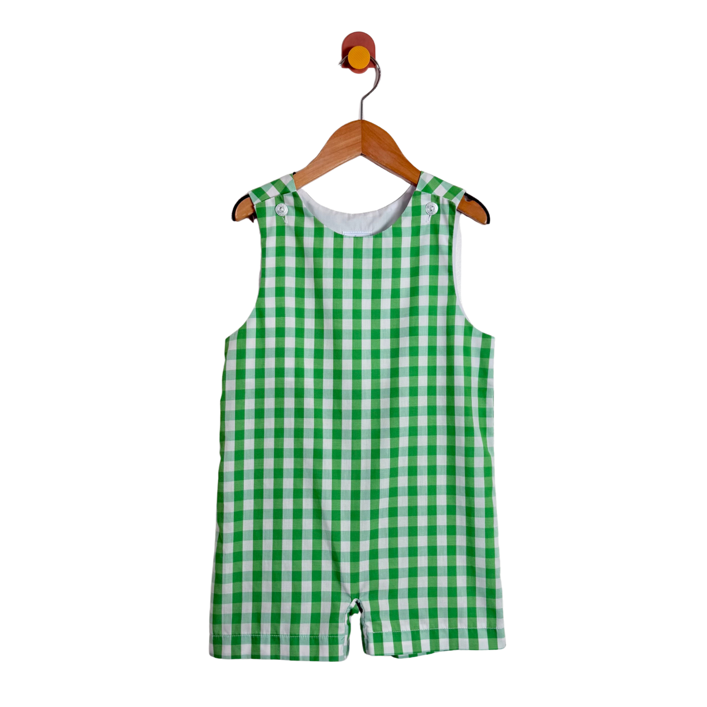 Green checkered romper on a hanger against a white background