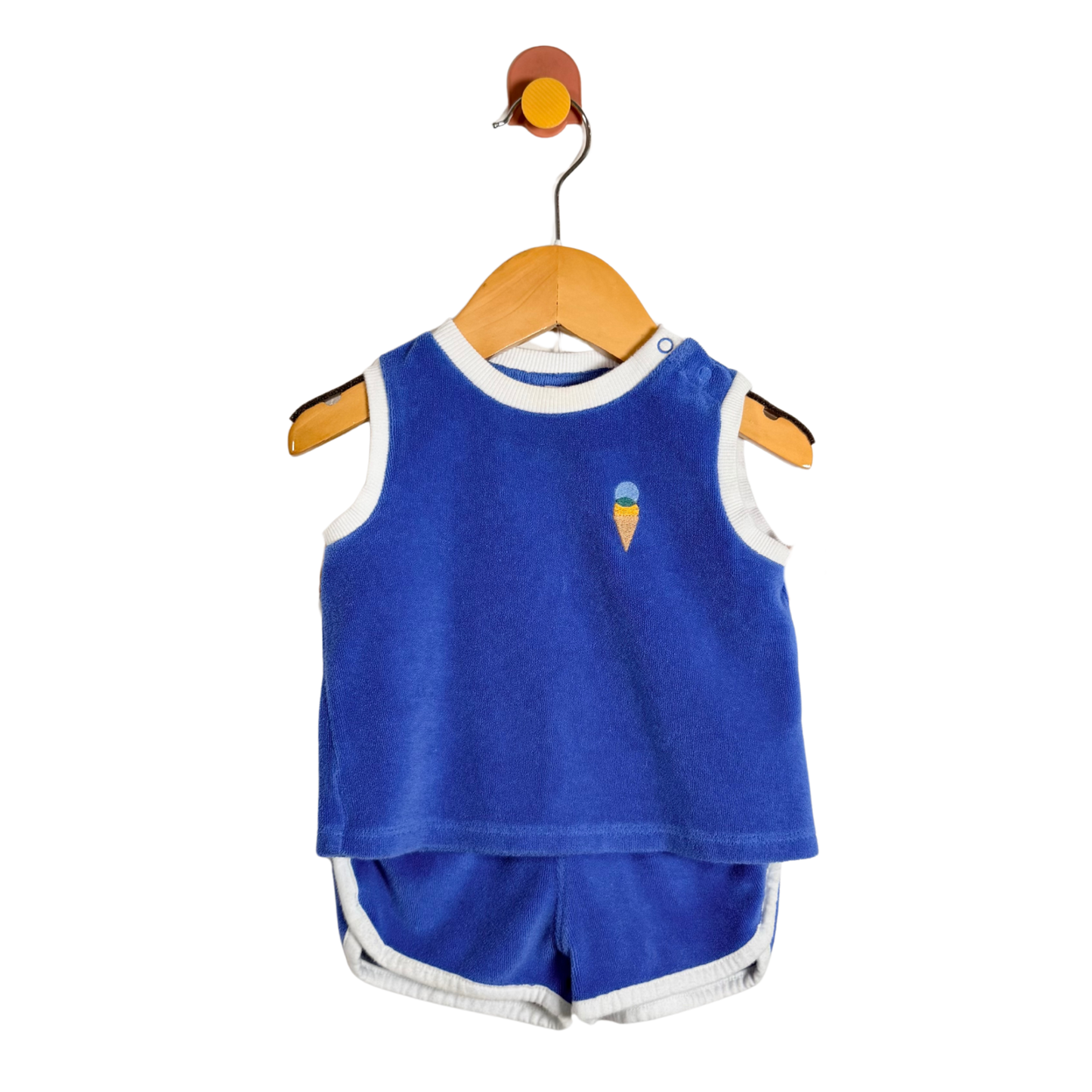 Blue sleeveless top and shorts set on a hanger against a white background