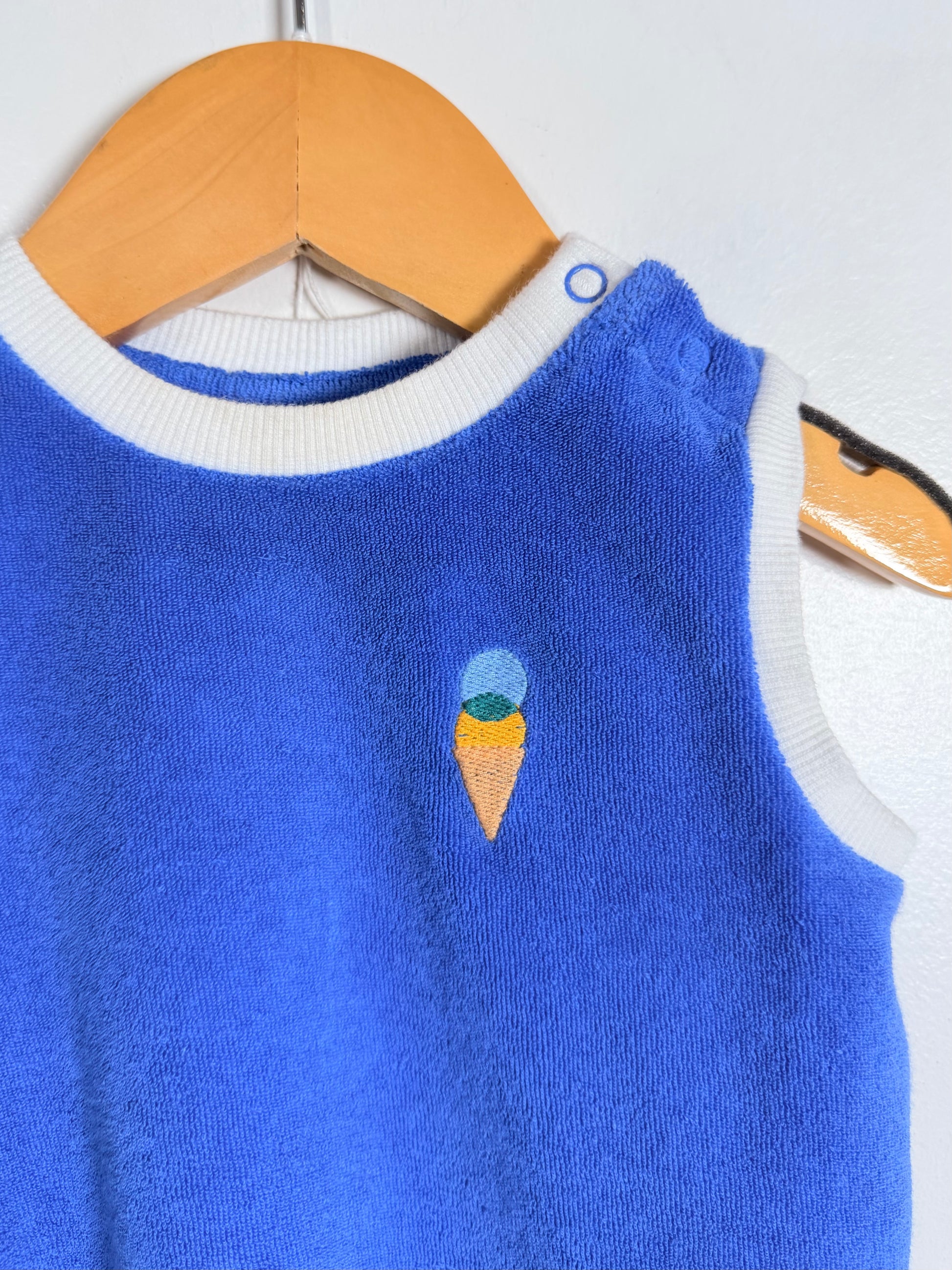 Blue sweater with ice cream cone design on a hanger