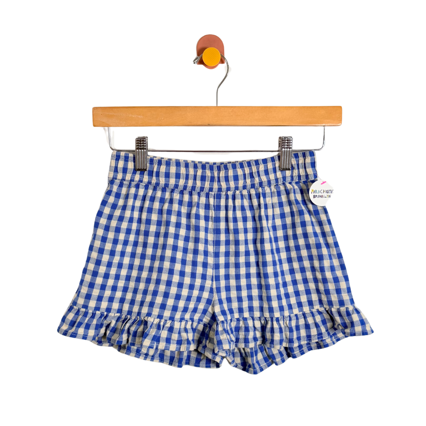 Blue and white checkered shorts on a hanger with a white background