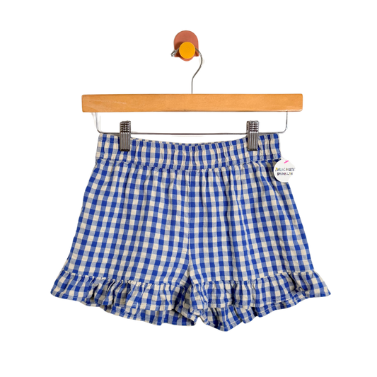 Blue and white checkered shorts on a hanger with a white background