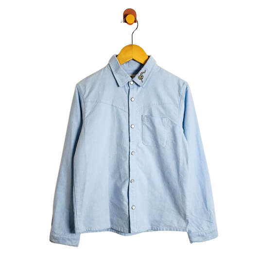 Light blue shirt on a yellow hanger against a white background