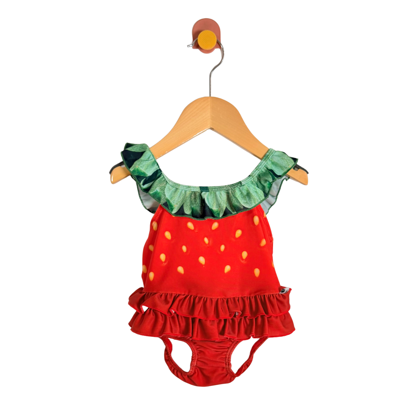 Strawberry-themed children's outfit on a hanger against a white background