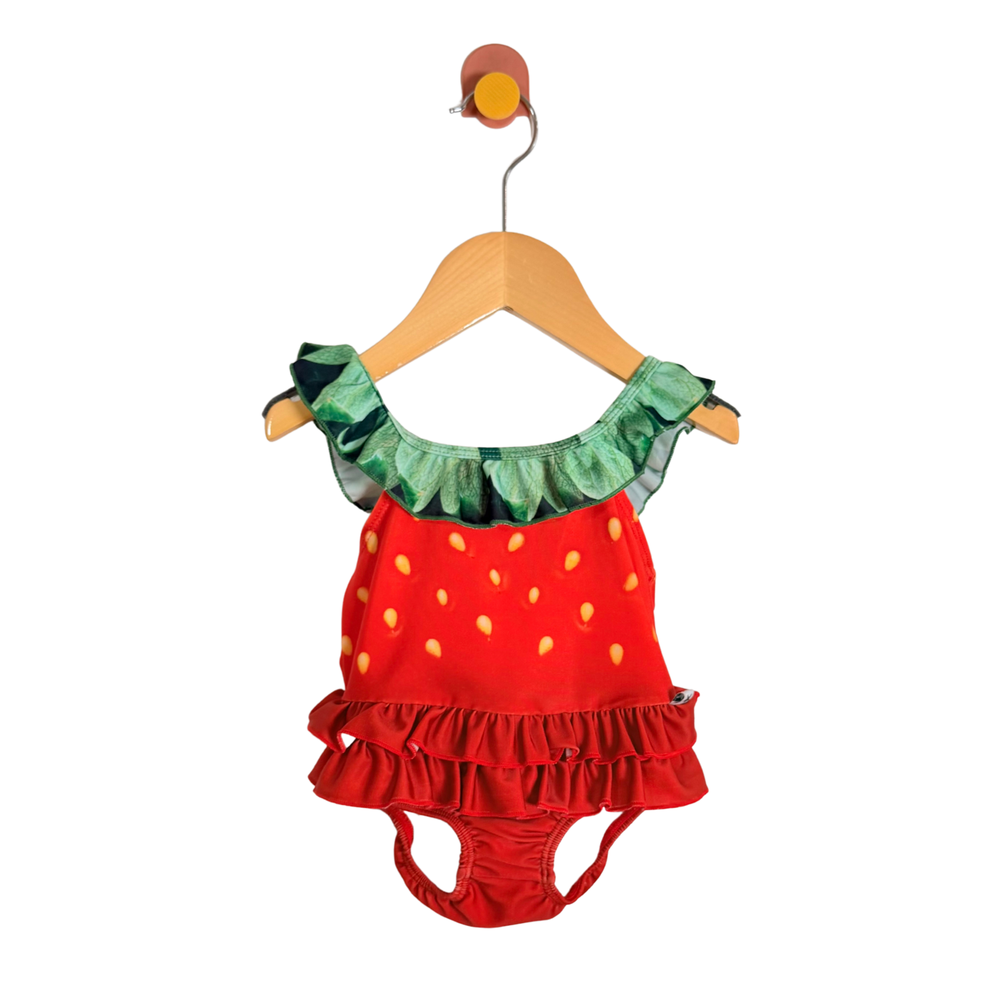 Strawberry-themed children's outfit on a hanger against a white background