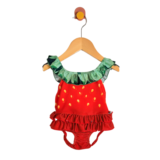 Strawberry-themed children's outfit on a hanger against a white background