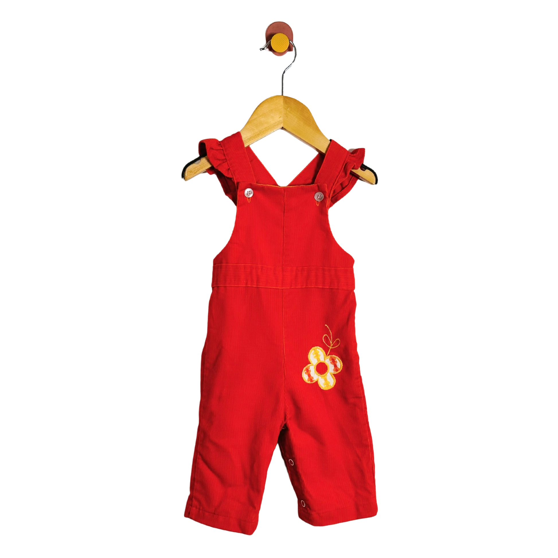 A baby orange overall romper with yellow embroidered floral details on the chest, hanging on a wooden hanger against a plain white background.