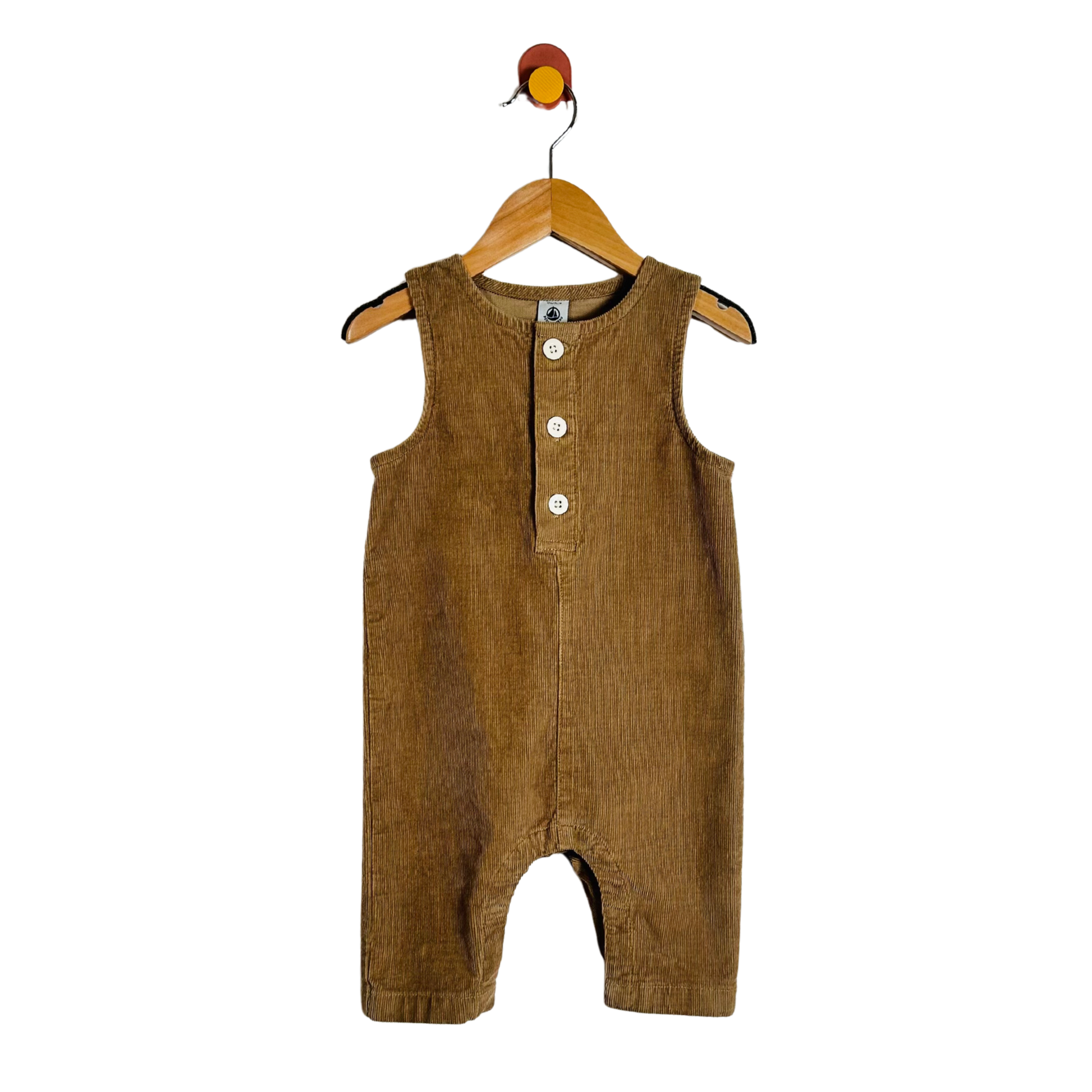 A brown corduroy baby romper hanging on a wooden hanger against a plain white background.