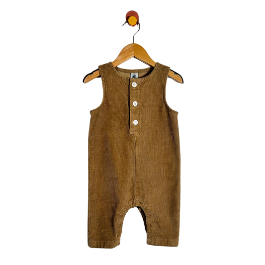 A brown corduroy baby romper hanging on a wooden hanger against a plain white background.