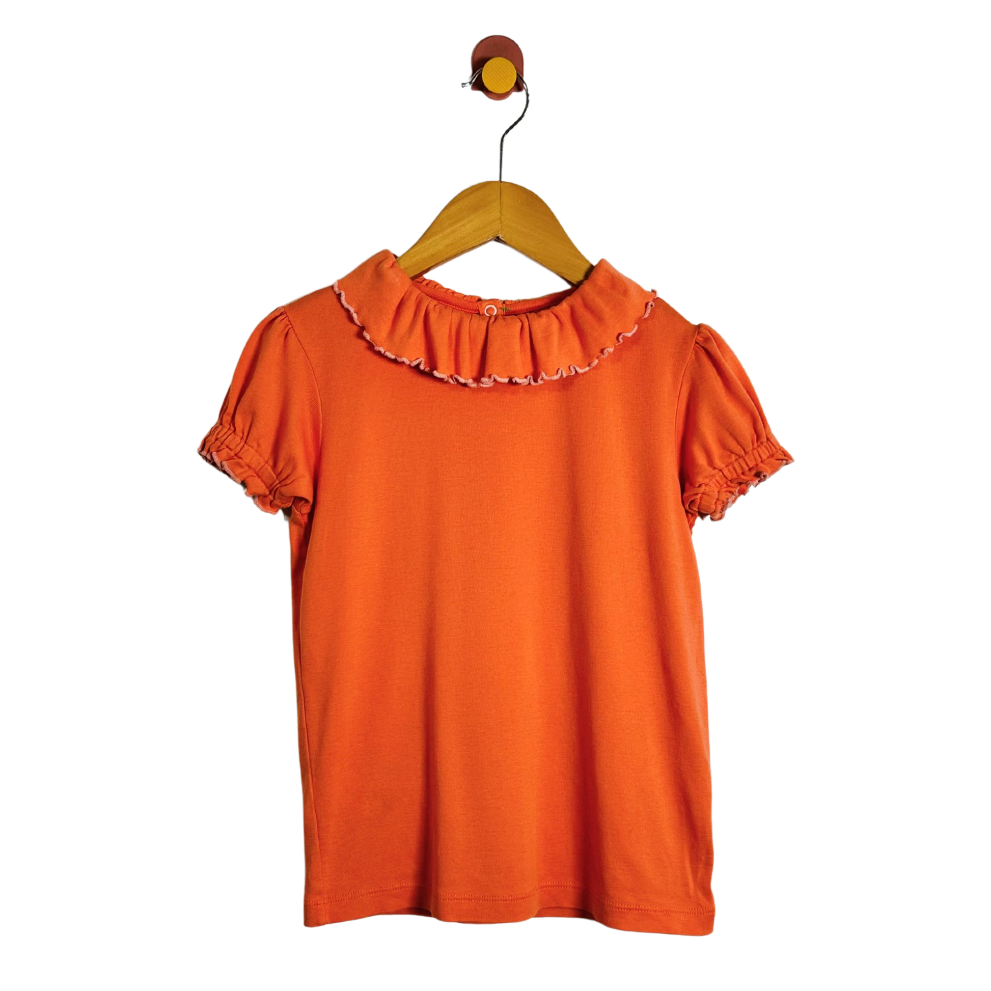 An orange short-sleeve blouse with a ruffled collar and puff sleeves, hanging on a wooden hanger against a plain white background.