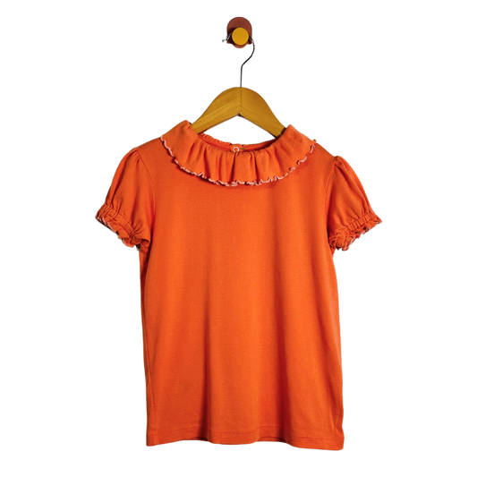 An orange short-sleeve blouse with a ruffled collar and puff sleeves, hanging on a wooden hanger against a plain white background.