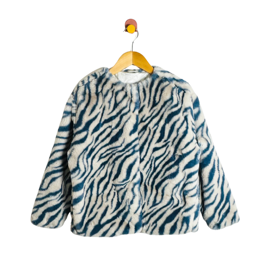 Zebra patterned coat on a hanger against a white background