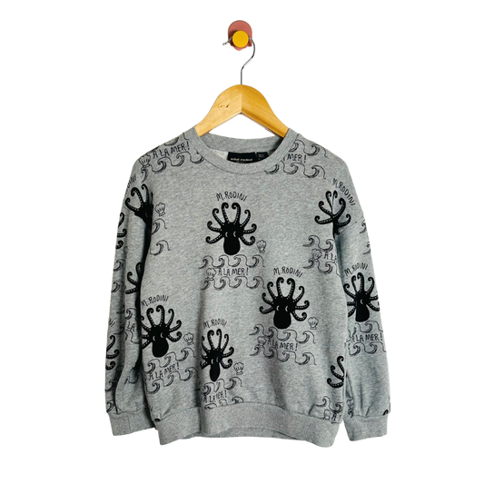 Gray sweatshirt with black octopus designs on a hanger against a white background