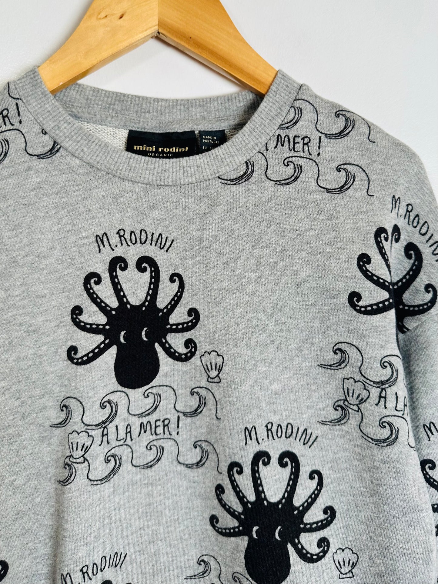 Gray sweater with black octopus design and 'M. Rodini' branding on a white background