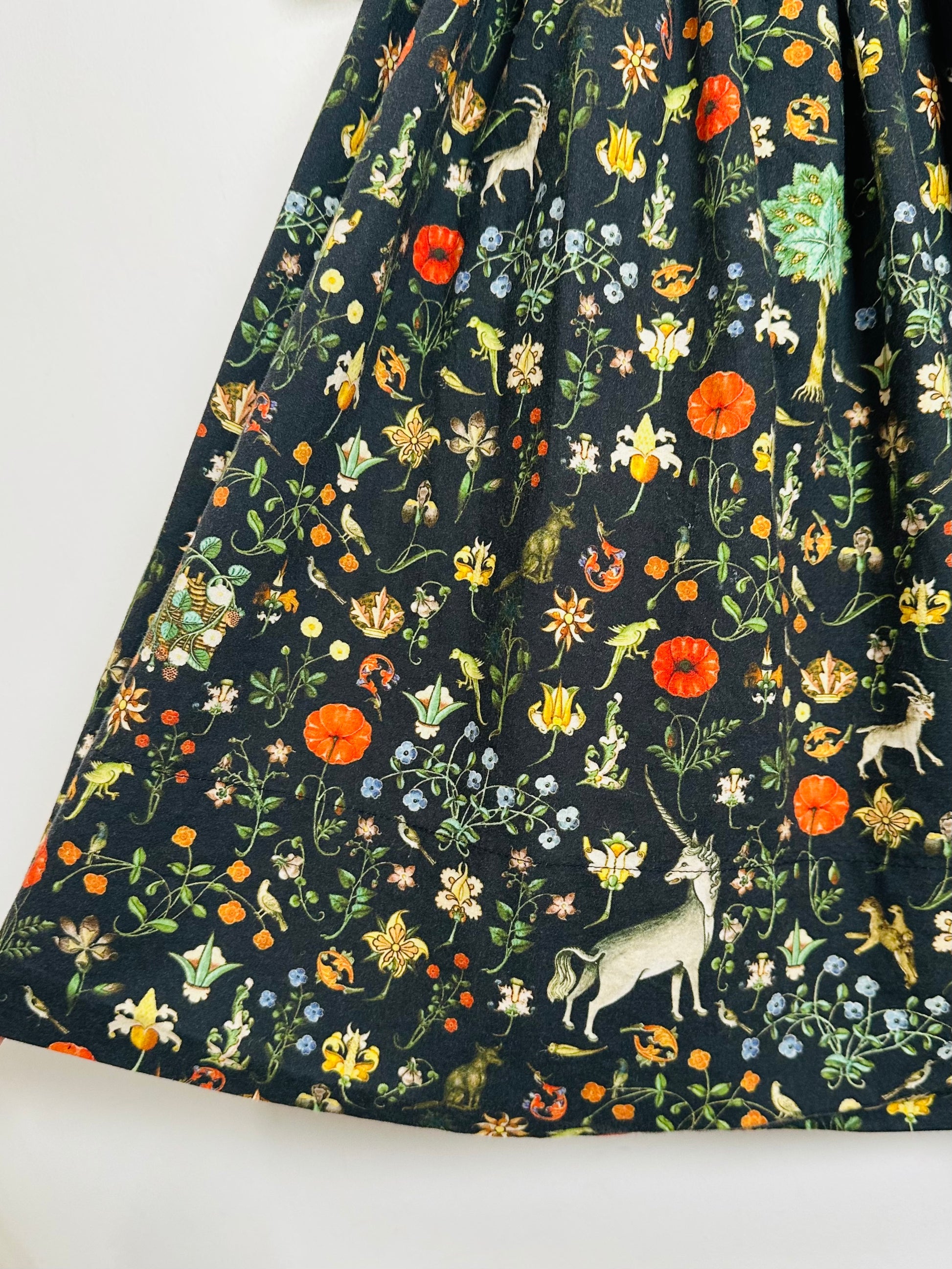 Floral and animal patterned fabric on a white background