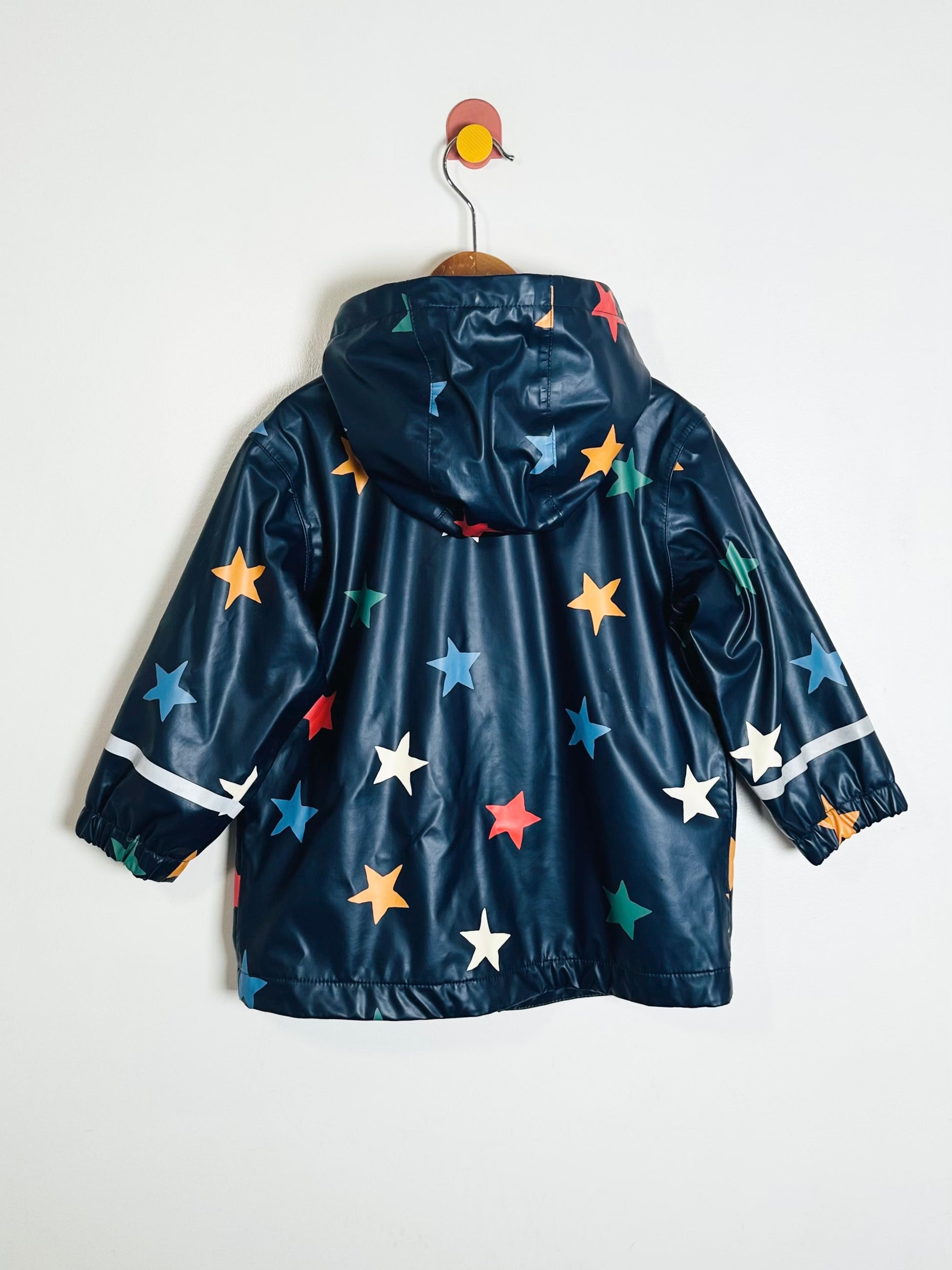 Children's raincoat with star patterns on a white background