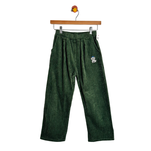 Dark green corduroy pants with an elastic waistband and a small embroidered dog patch on the left hip, hanging from a wooden hanger against a white background.