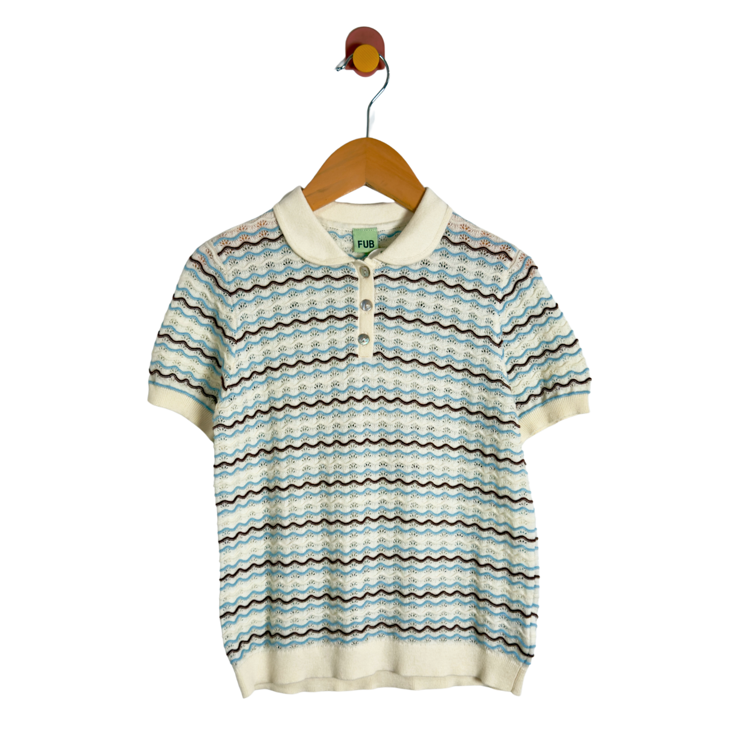 A short-sleeve knit polo shirt with a wavy horizontal stripe pattern in light blue, beige, and brown, hanging on a wooden hanger against a white background.