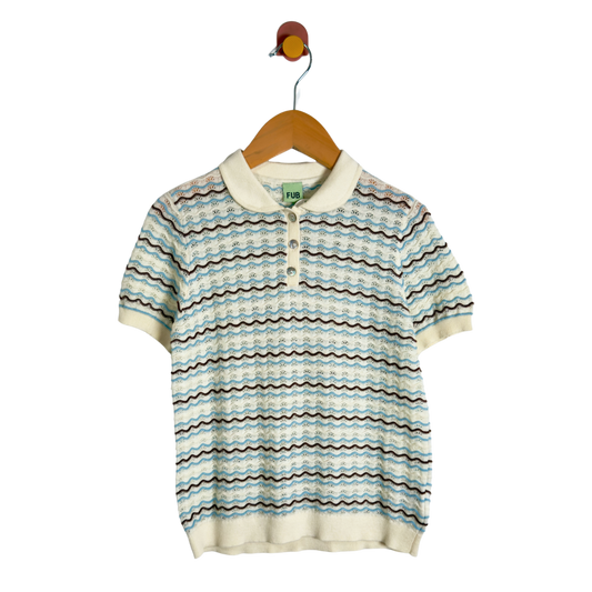 A short-sleeve knit polo shirt with a wavy horizontal stripe pattern in light blue, beige, and brown, hanging on a wooden hanger against a white background.