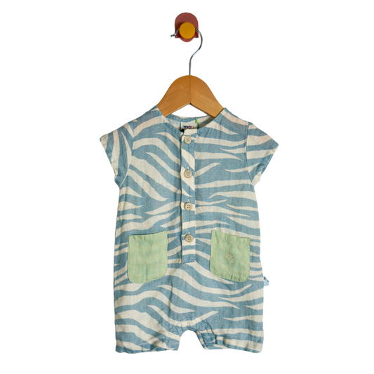 A baby short-sleeve romper with a blue and white zebra stripe pattern, featuring two light green front pockets and a button-up front, hanging on a wooden hanger against a white background.