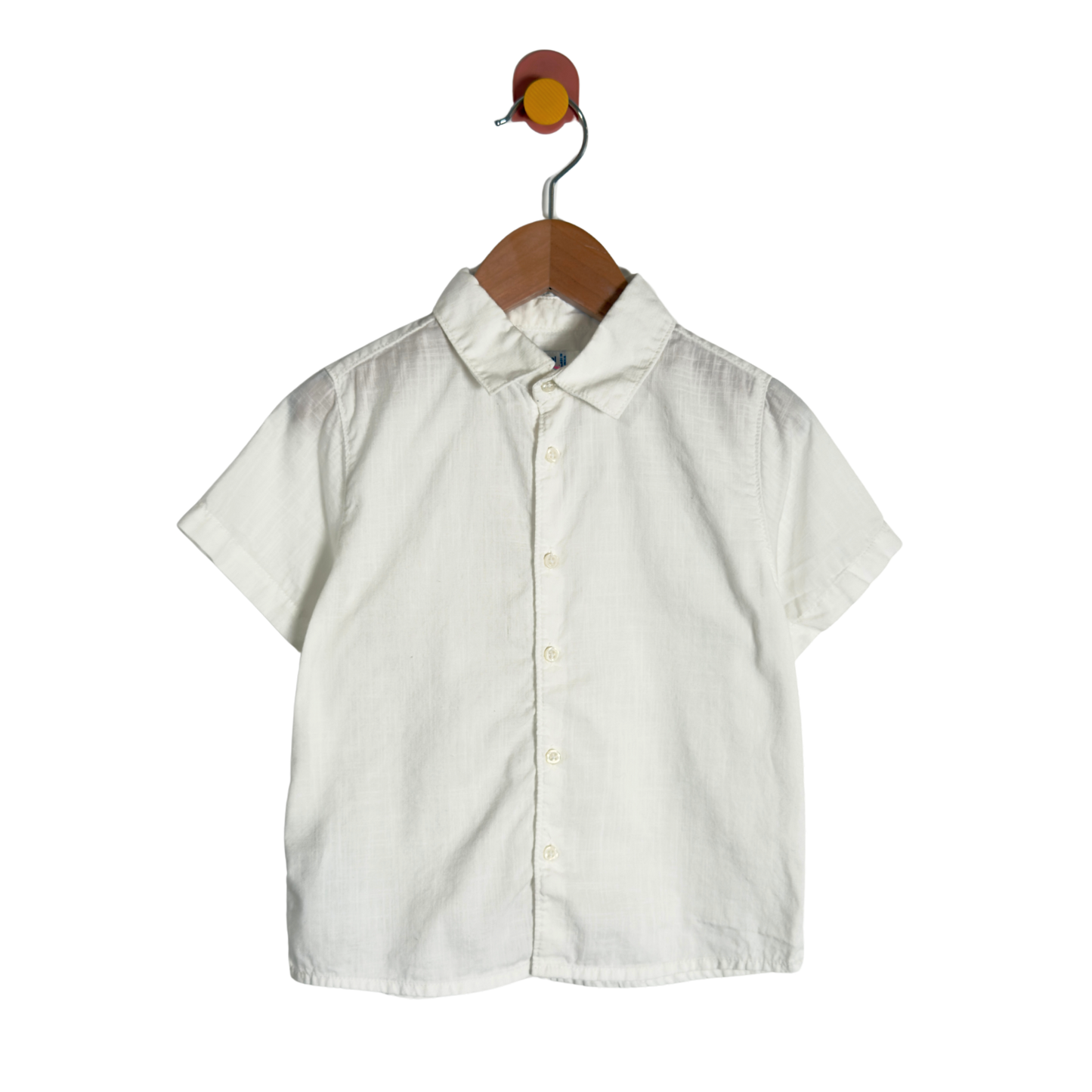 A short-sleeve button-up shirt in off-white linen fabric, hanging on a wooden hanger against a plain white background.