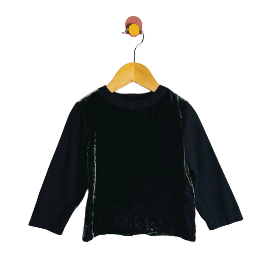 Black long-sleeve shirt on a wooden hanger against a white background