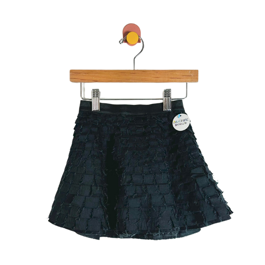 Black tiered skirt on a hanger with a visible brand tag against a white background
