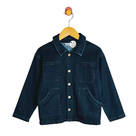 Blue denim jacket on a hanger with a white background