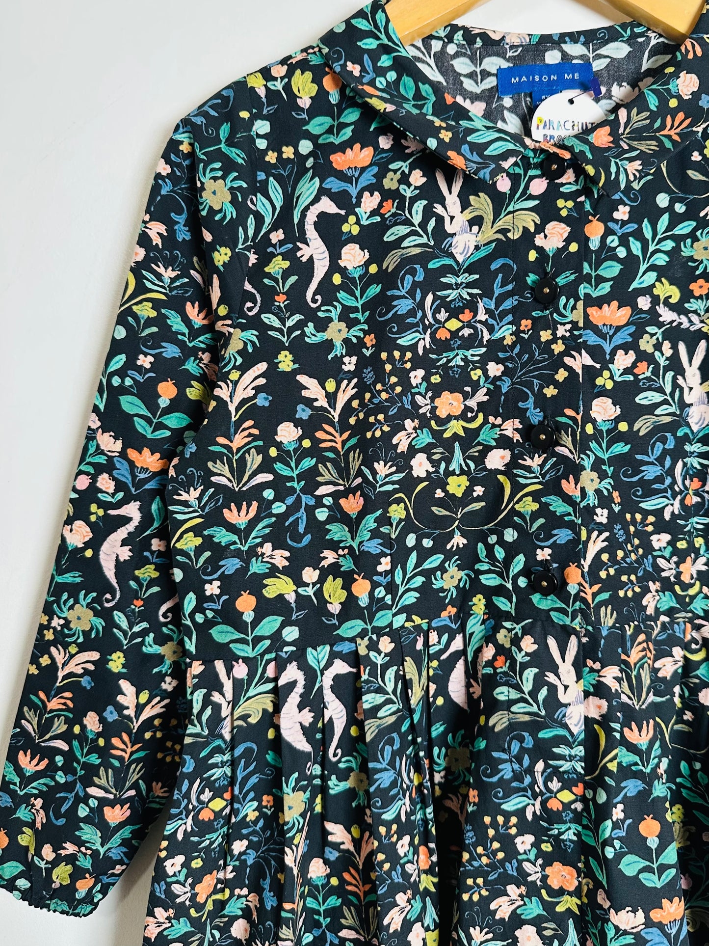 Floral patterned shirt with colorful designs on a white background