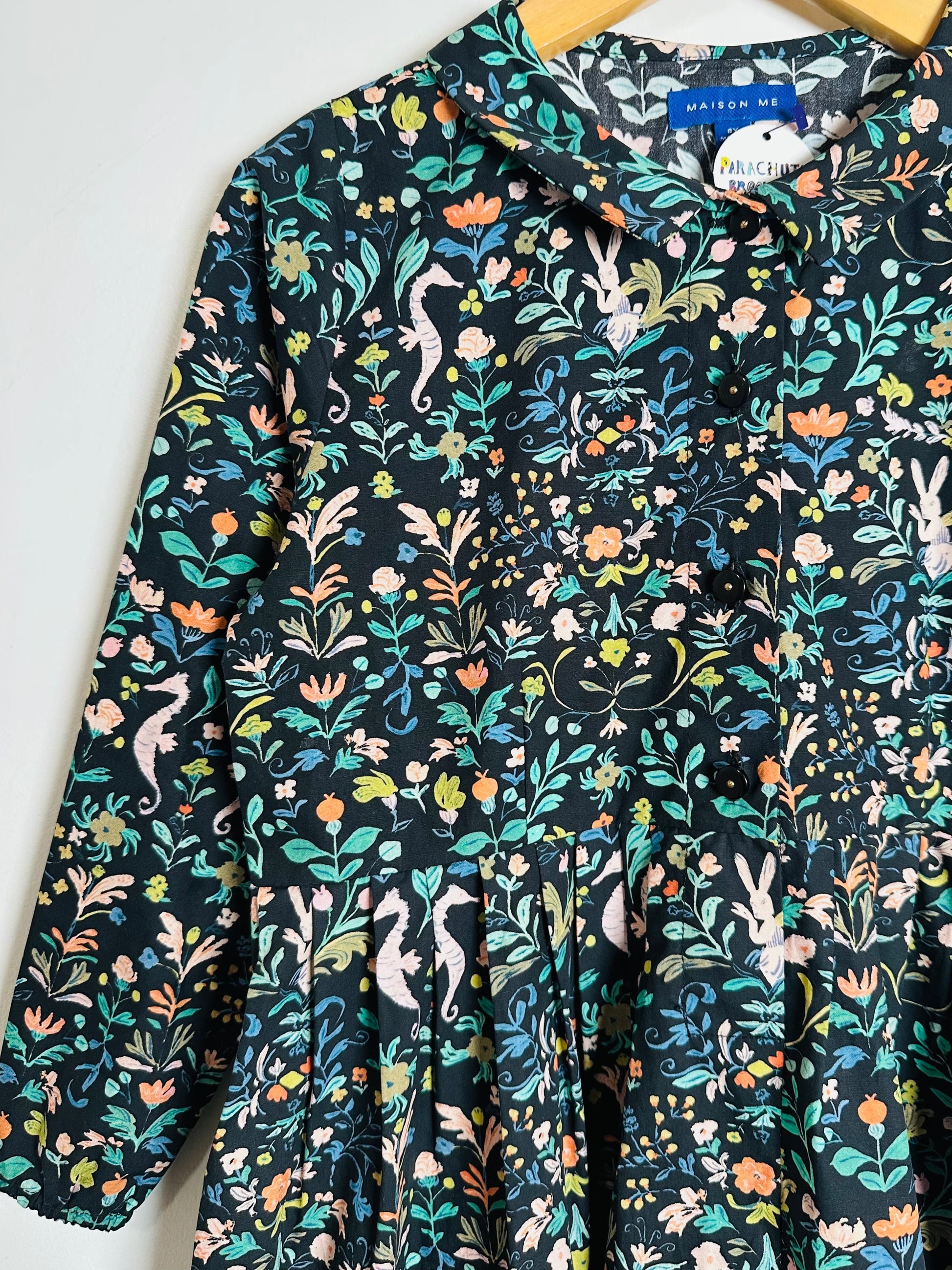 Floral patterned shirt with colorful designs on a white background