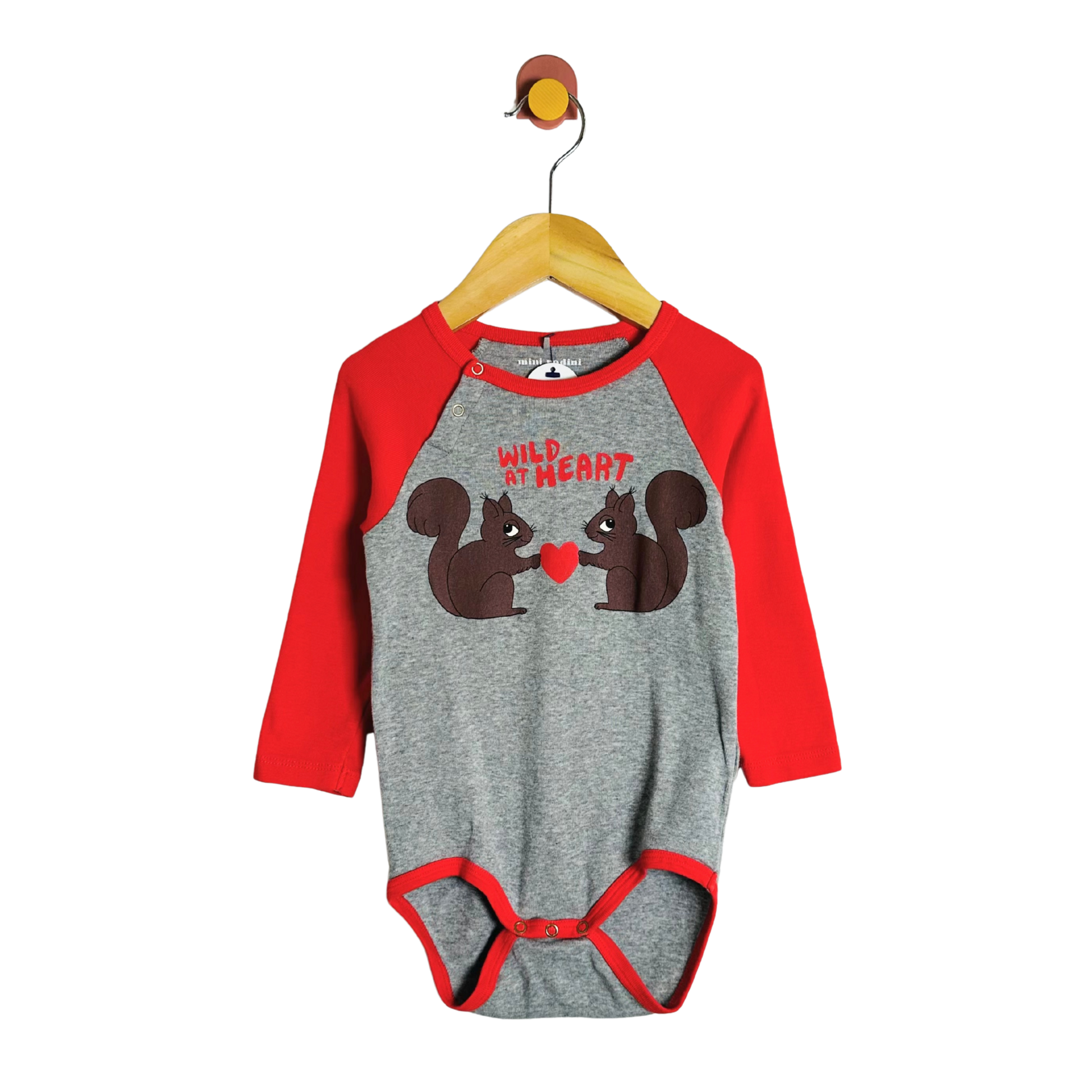 Gray and red baby onesie with squirrel design on a hanger against a white background
