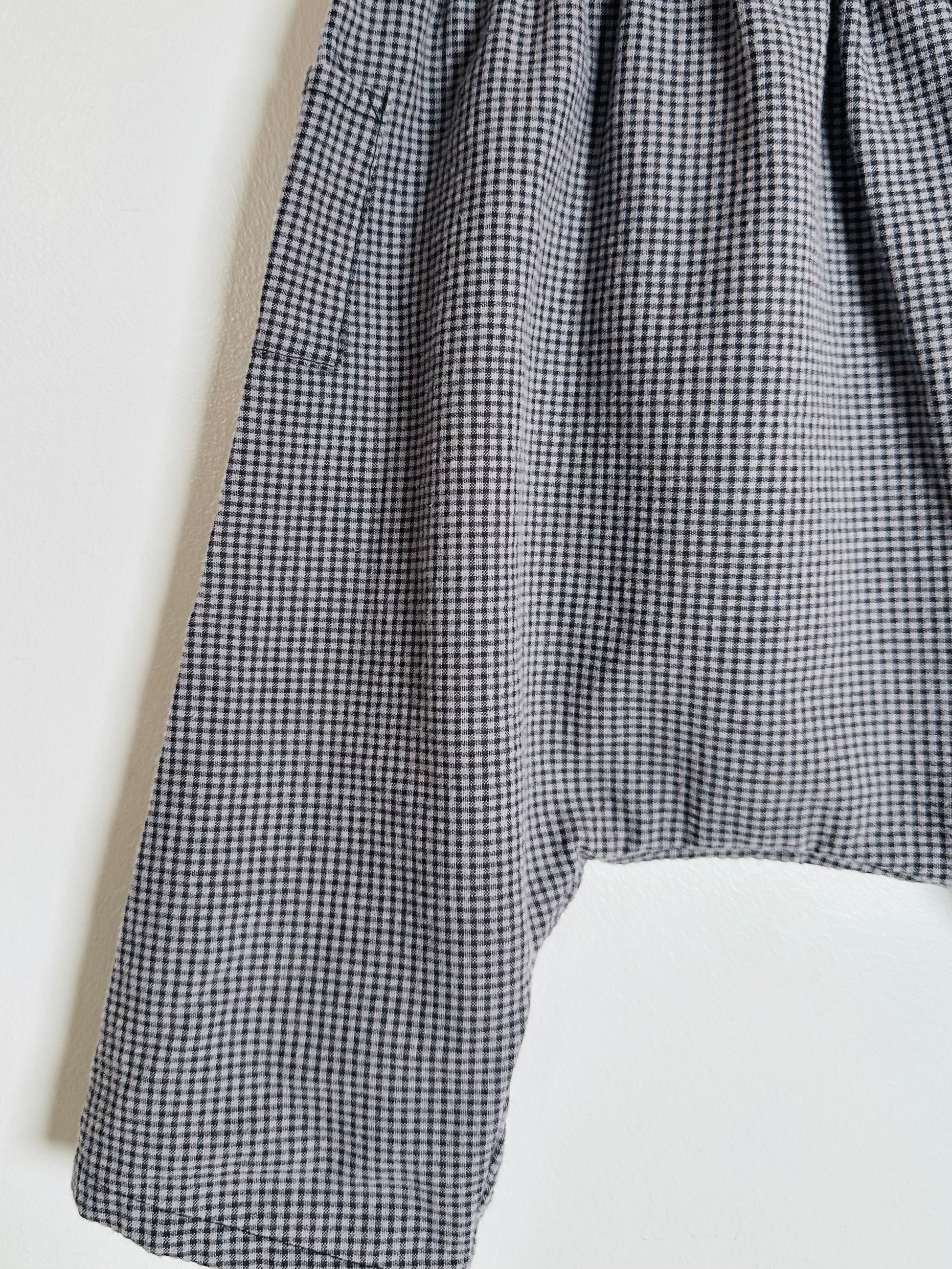 Black and white checkered pants on a white background