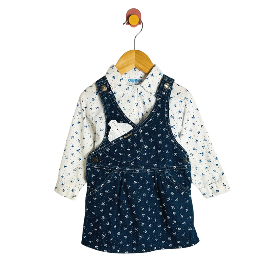 Children's outfit with navy pinafore and floral shirt on a hanger