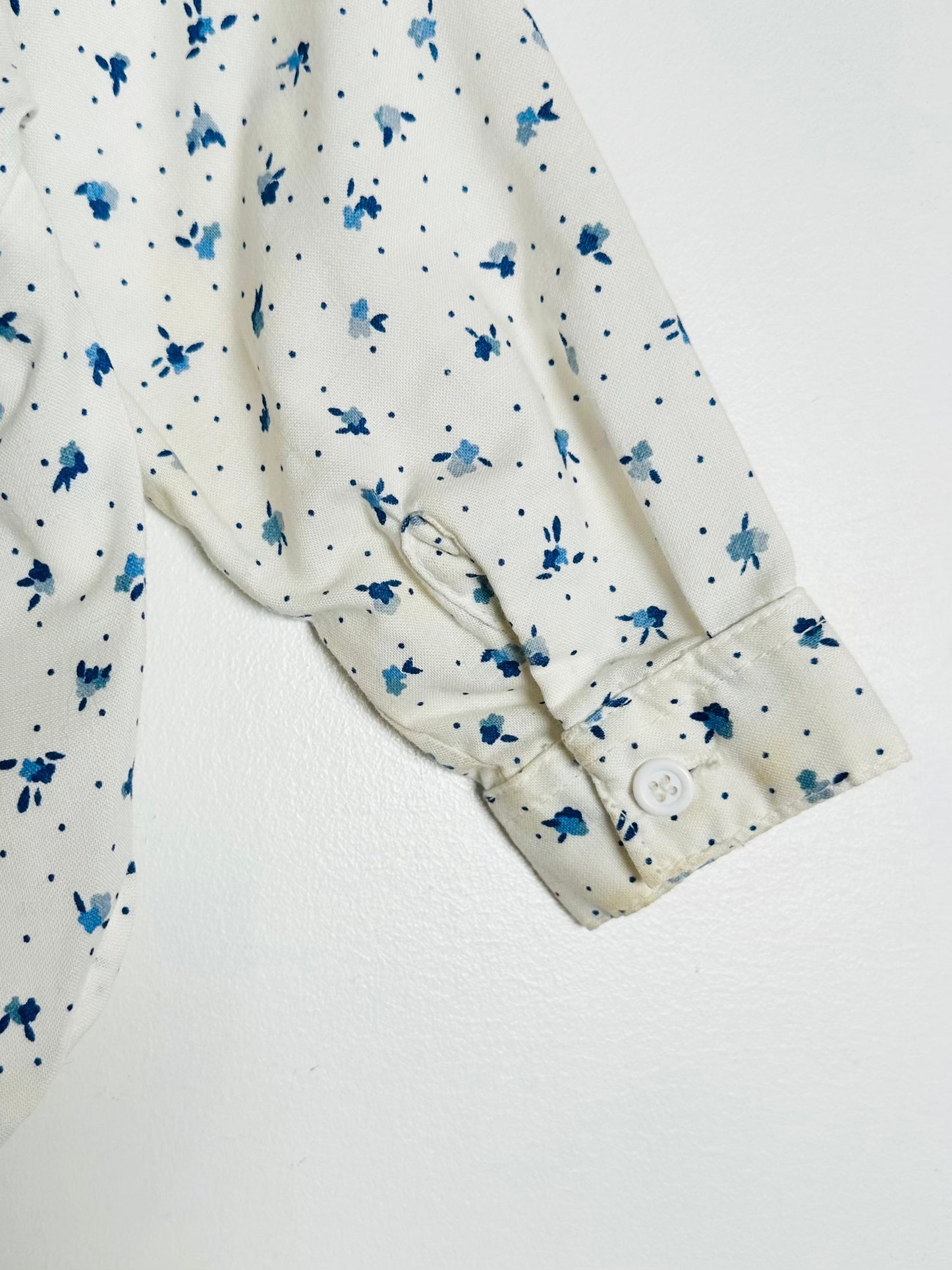 White shirt with blue floral pattern on a white background