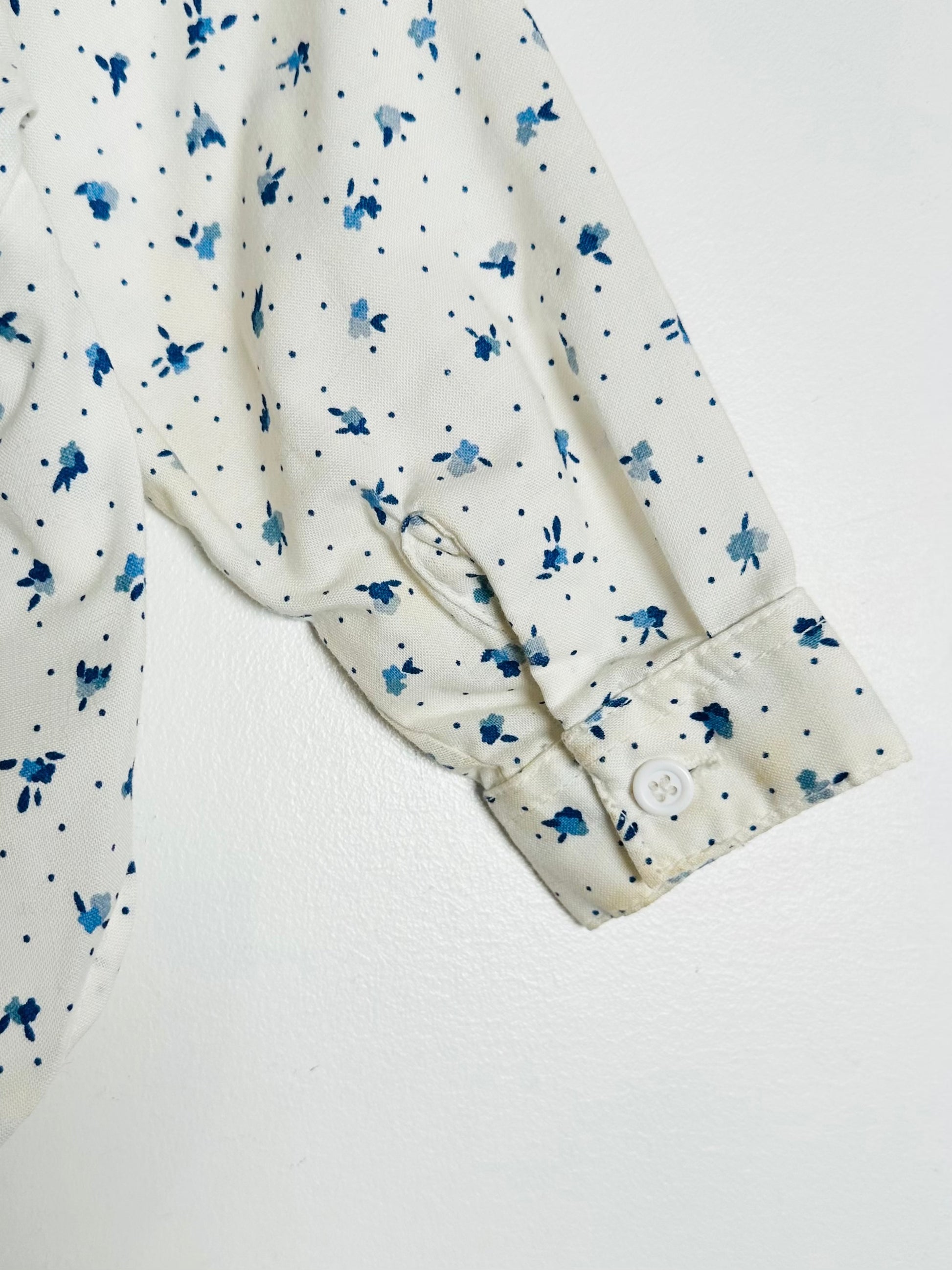 White shirt with blue floral pattern on a white background