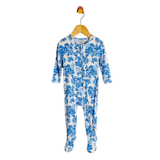 Blue floral-patterned onesie on a hanger against a white background