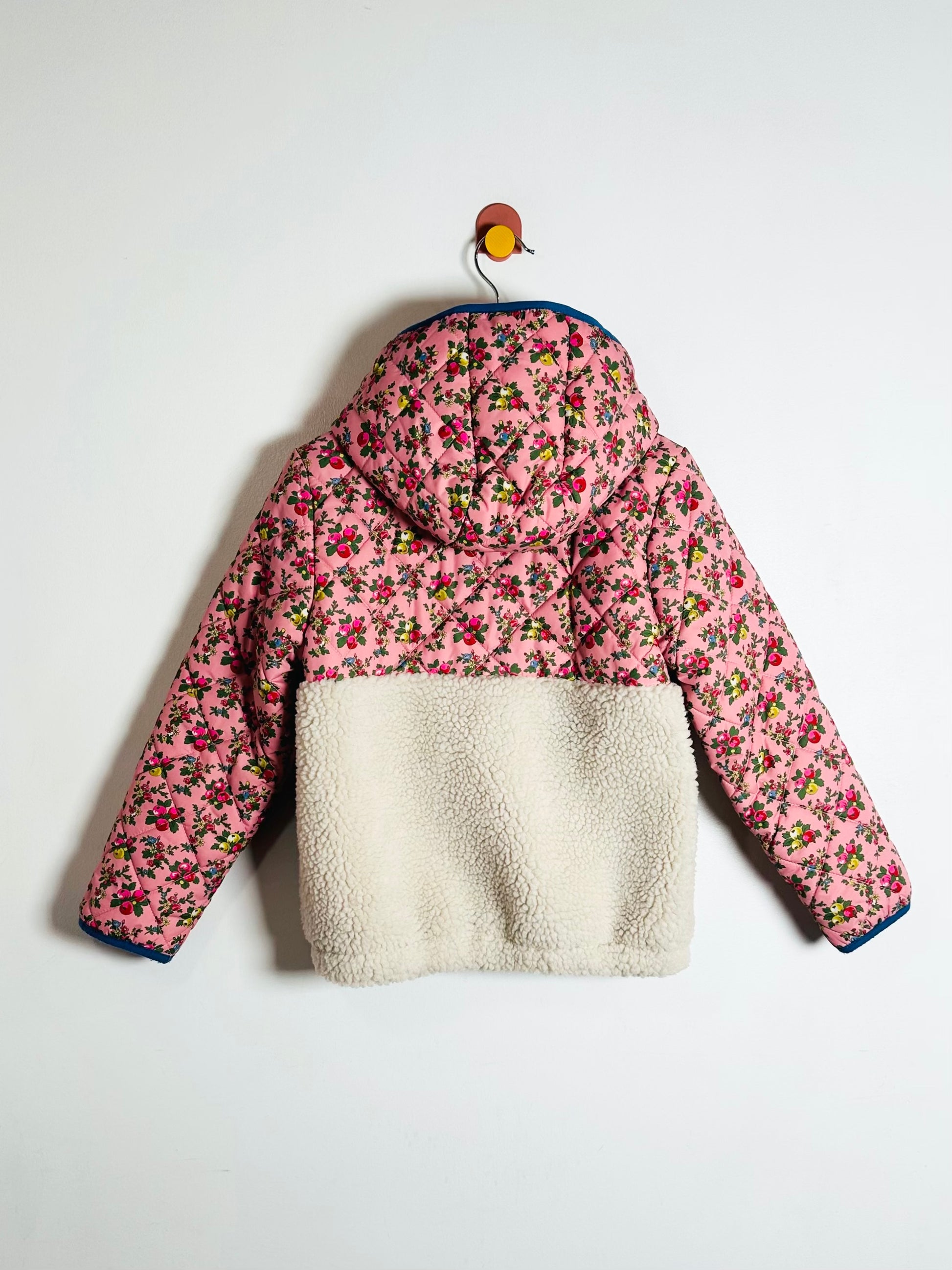 Floral patterned jacket with white fleece lining on a white background
