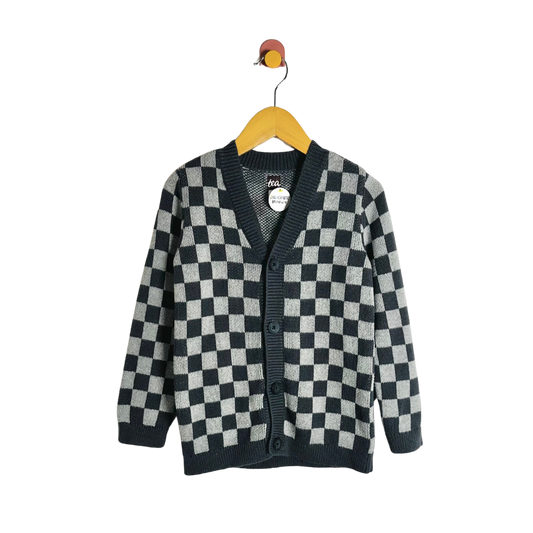 Checkered cardigan on a hanger against a white background