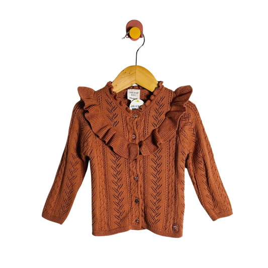Brown knitted jacket on a wooden hanger with a white background