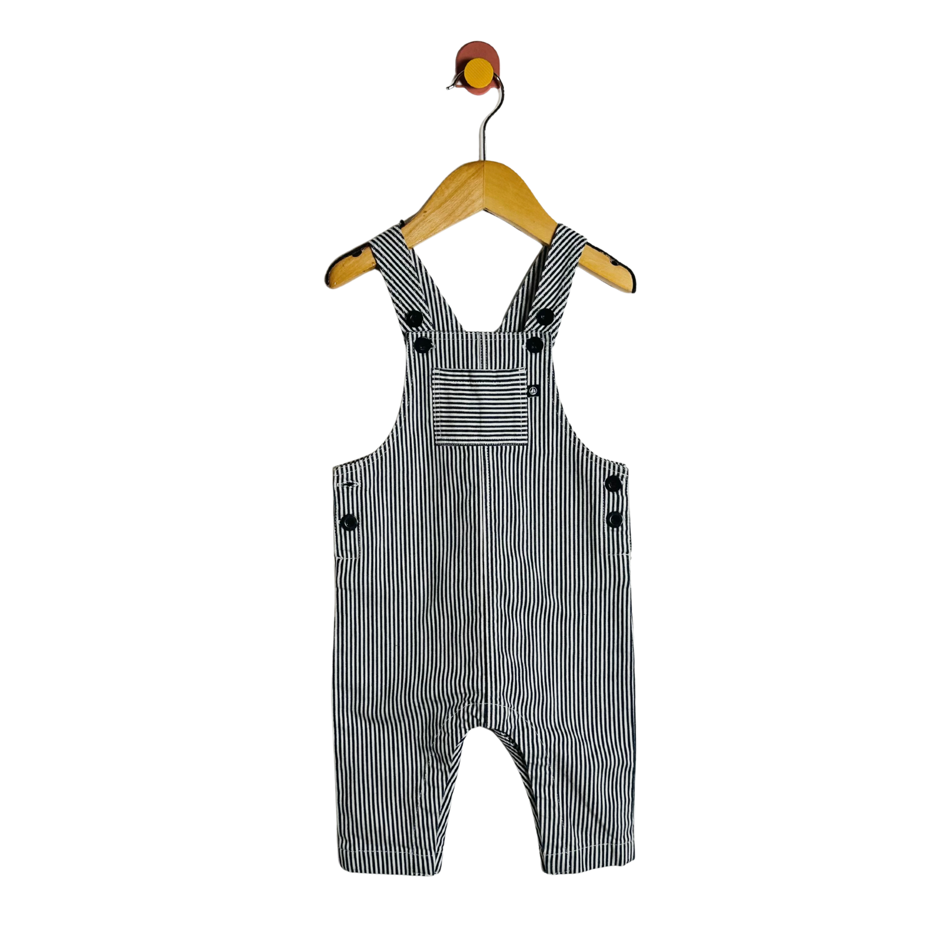 Black and white striped overalls on a hanger against a white background