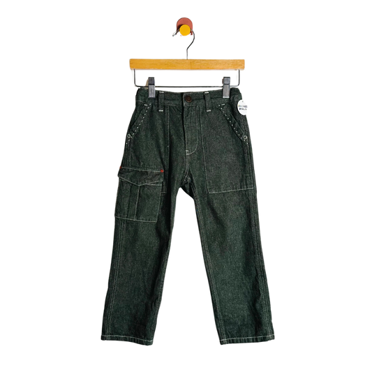 Green denim pants on a hanger against a white background