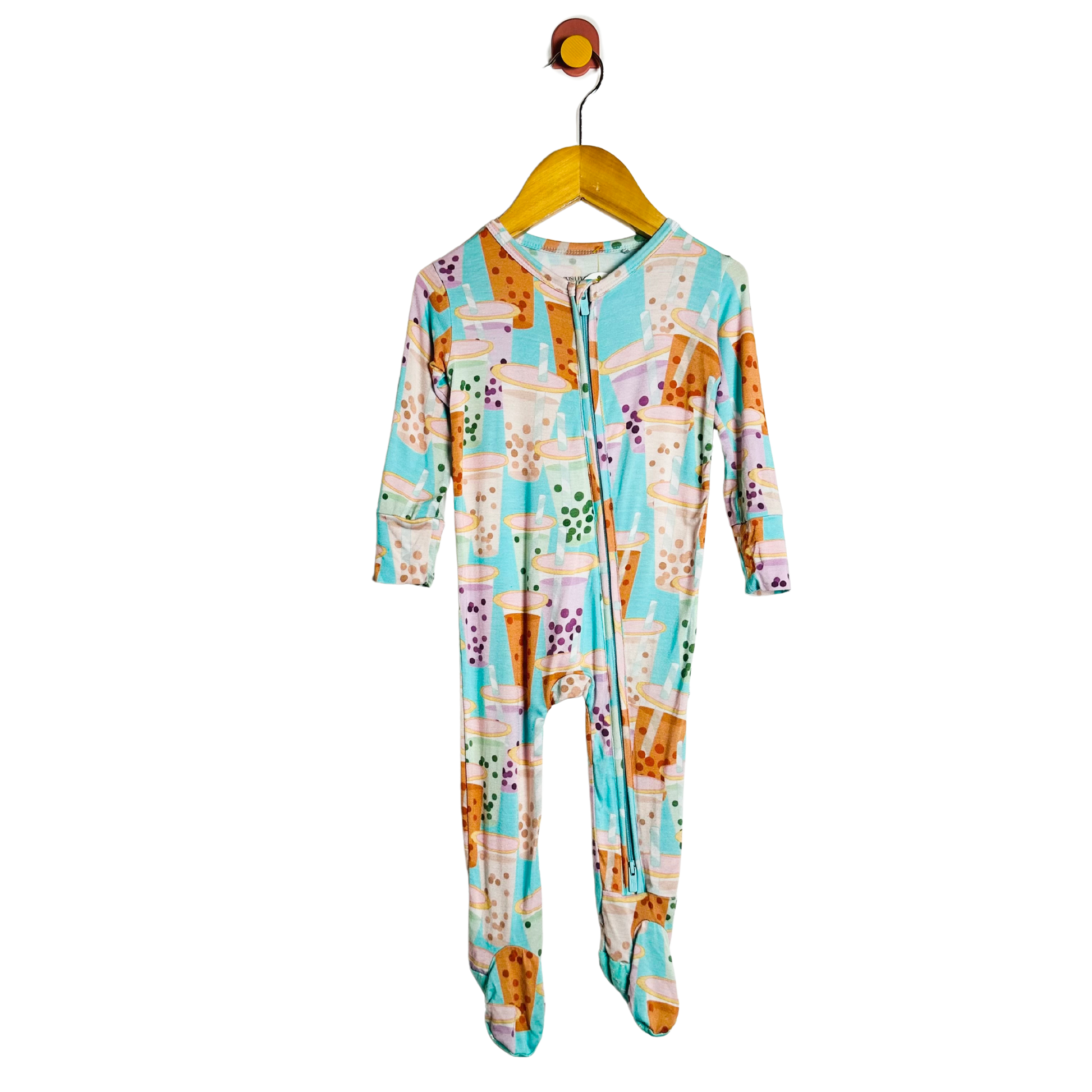 Colorful onesie with a pattern on a hanger against a white background
