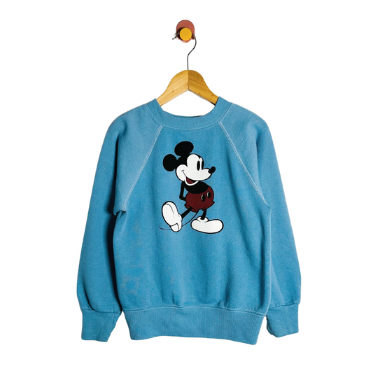 Blue sweatshirt with a cartoon character on a hanger against a white background