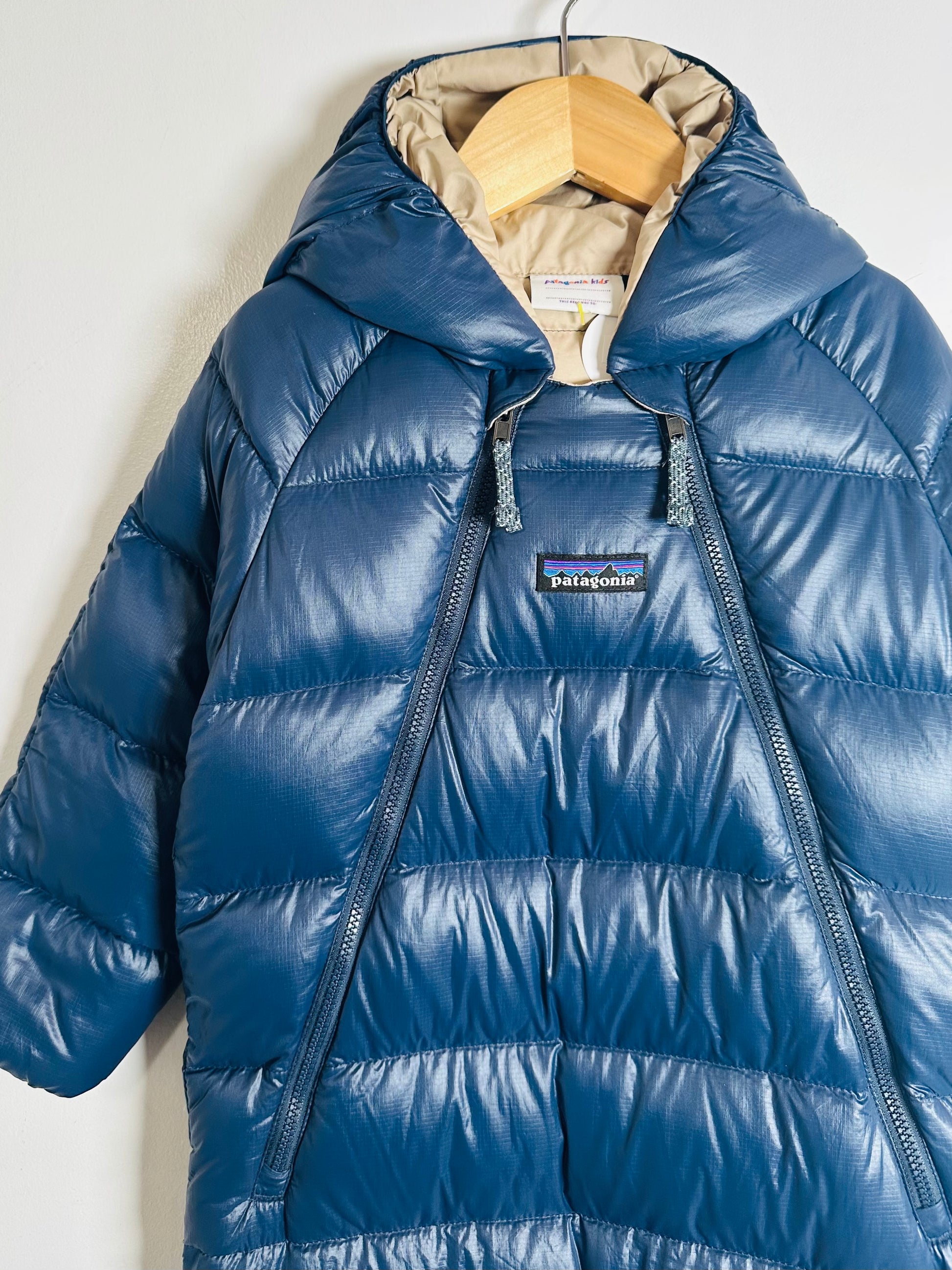 Blue puffer jacket with a Patagonia logo on a white background