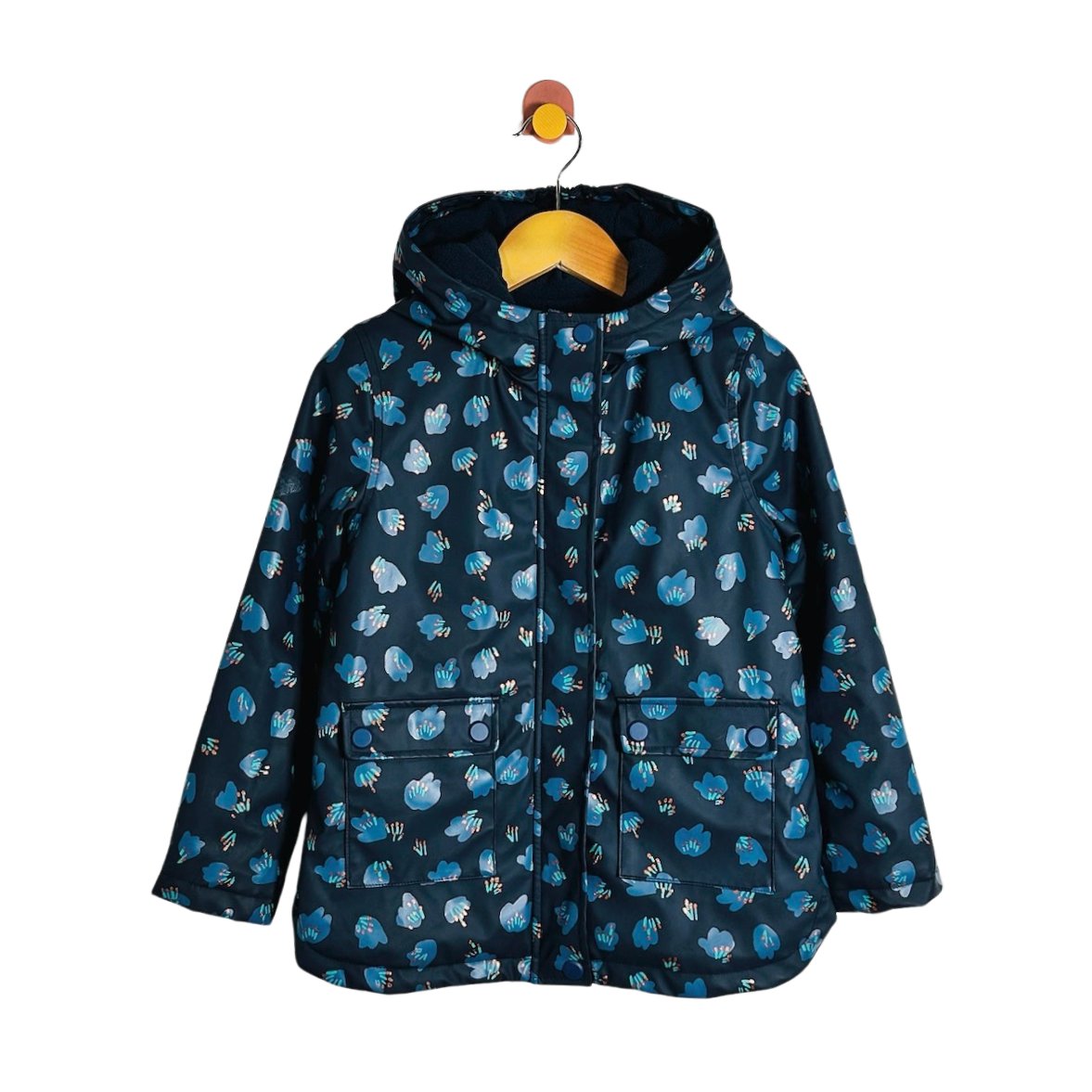 A hooded children's jacket in navy blue with a repeating light blue and white animal print, hanging on a wooden hanger against a plain white background.