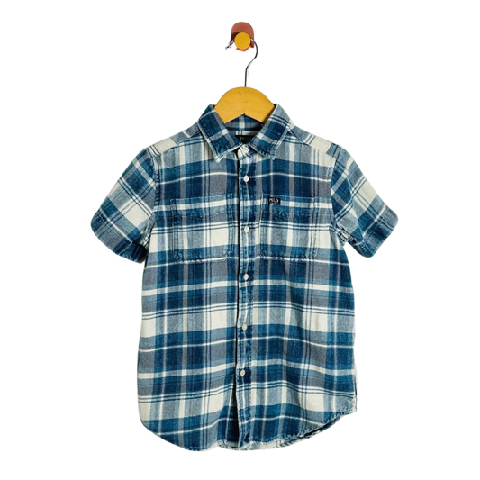 A short-sleeve plaid button-up shirt in blue and white, hanging on a wooden hanger against a plain white background.