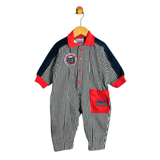 Striped baby romper with red accents on a hanger against a white background