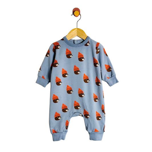Blue baby onesie with bear pattern on a hanger against a white background