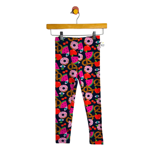 Colorful patterned leggings on a hanger against a white background