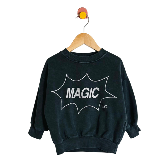 Black sweatshirt with 'MAGIC B.C.' print on a hanger against a white background