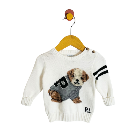 White sweater with dog design on a hanger against a white background